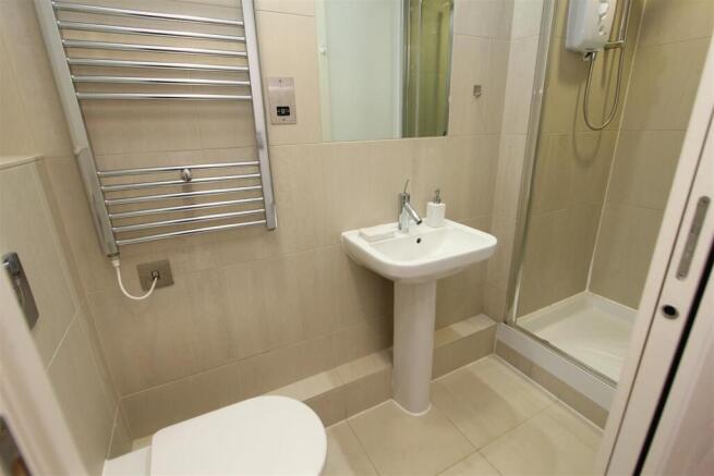 Modern tiled bathroom with heated towel rail...