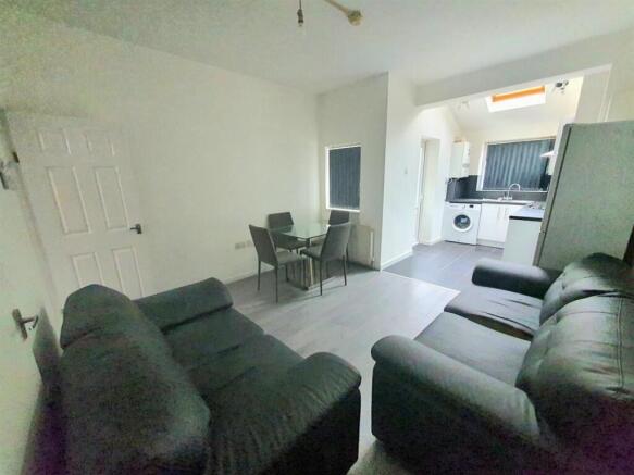 Spacious open-plan lounge with plush sofas and ...