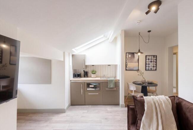 Modern open plan kitchen with skylight and dini...