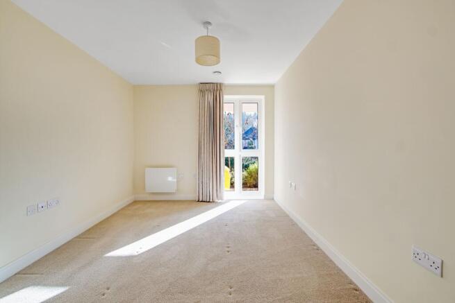 a room with a carpet and a window