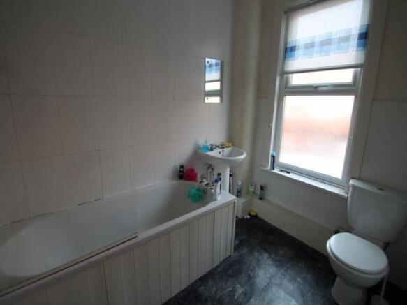 A bright and clean bathroom featuring a toilet,...