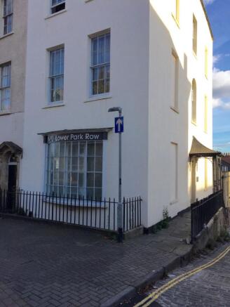 Elegant white period building with large window...