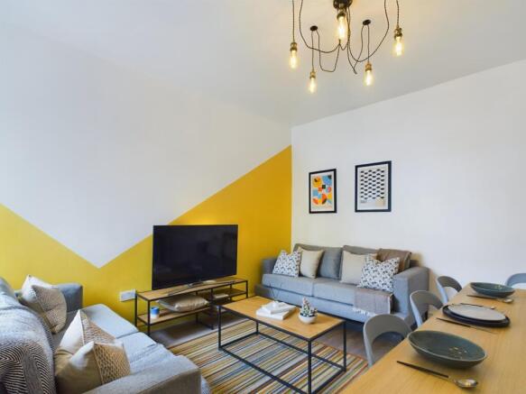 A stylish and inviting living room featuring co...