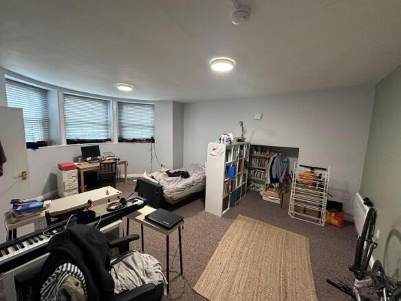 Spacious, multi-purpose bedroom with a large ba...