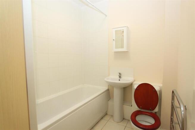 Bright bathroom with full tub and storage cabin...