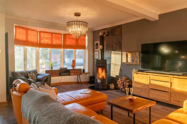 Spacious lounge with log burner
