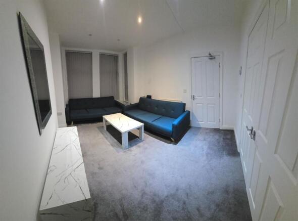 Modern living area with sleek blue sofas...
