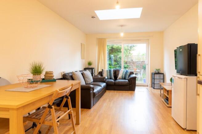 This spacious living room features a comfortabl...