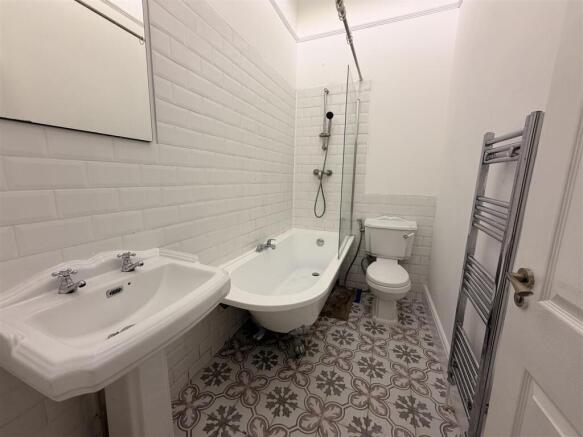 Bright bathroom with chic patterned flooring...
