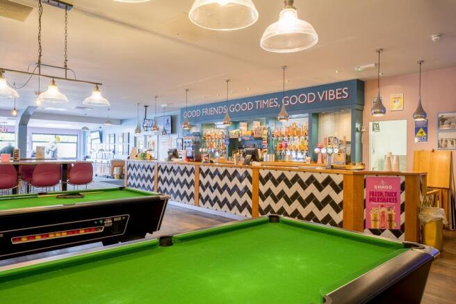 Bar area with pool tables and drinks counter at Bi