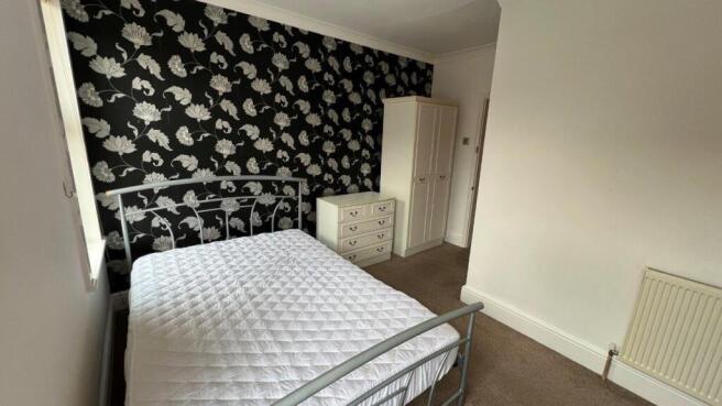 Bright double bedroom with stylish feature wall...