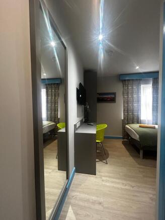 Bright, well-kept bedroom with wood-effect floo...