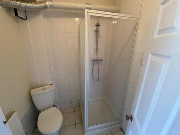 Bright, modern shower room with crisp tiling....
