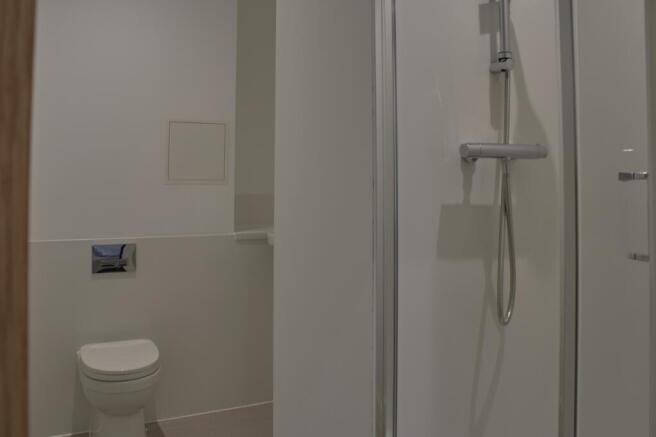 A modern and tidy bathroom featuring a spacious...