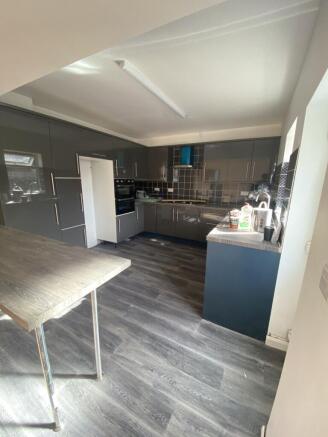 Modern kitchen featuring sleek grey cabinetry w...