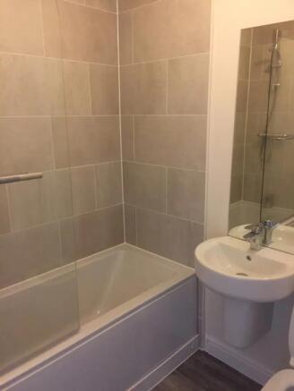 A modern bathroom featuring a sleek design with...