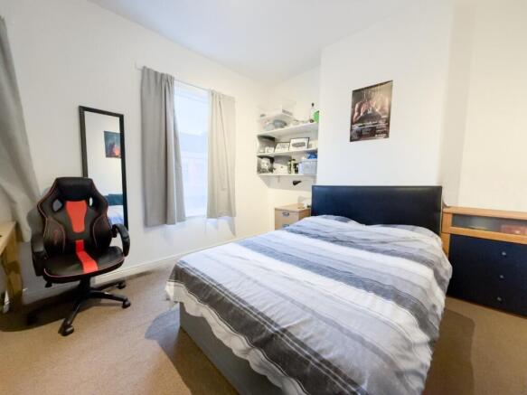 Bright double bedroom with desk and shelving...