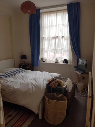 A cozy double bedroom featuring good natural li...