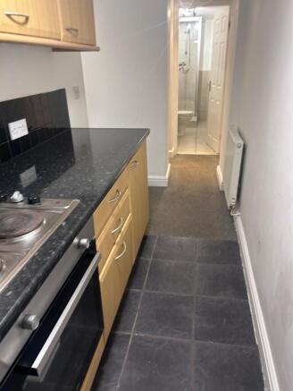 A functional kitchenette with ample storage and...