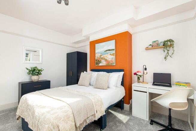 Bright, stylish bedroom with double bed and des...