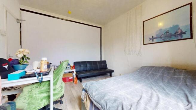 A cozy double bedroom featuring a comfortable b...