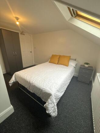 Bright, neatly presented bedroom with a comfort...
