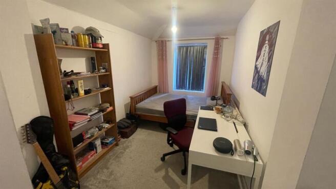 Bright bedroom with ample storage and study des...