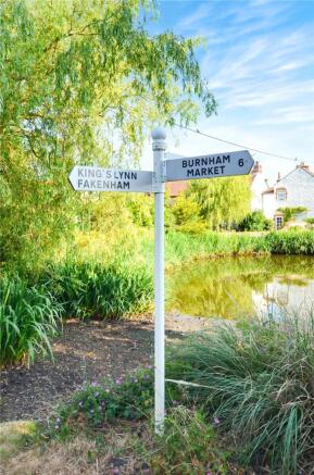 Signpost By Pond