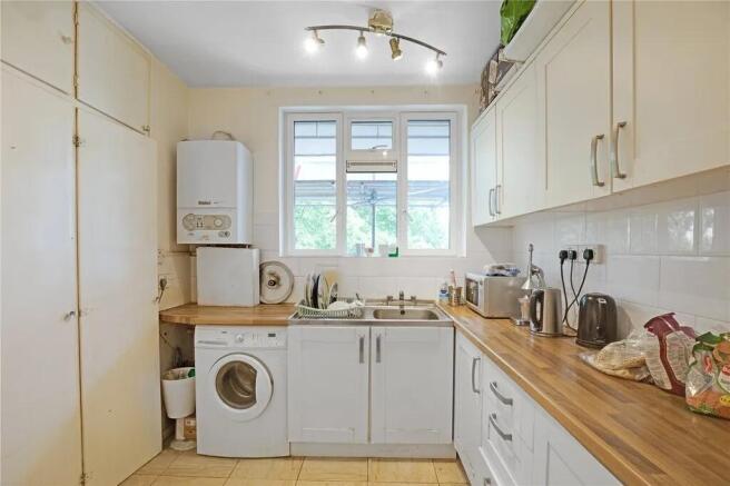 Bright kitchen with ample storage and laundry...
