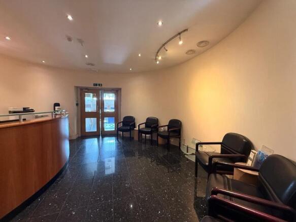 Bright, welcoming reception area with curved wo...