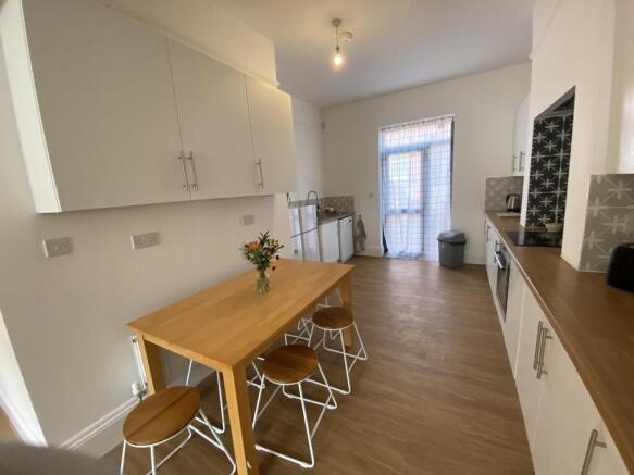 Bright, modern kitchen with wood-effect floorin...