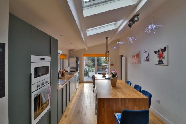 Extended Vaulted Island Kitchen matt green cupboar