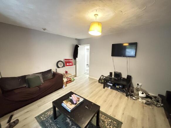 A modern, well-lit living room featuring a comf...