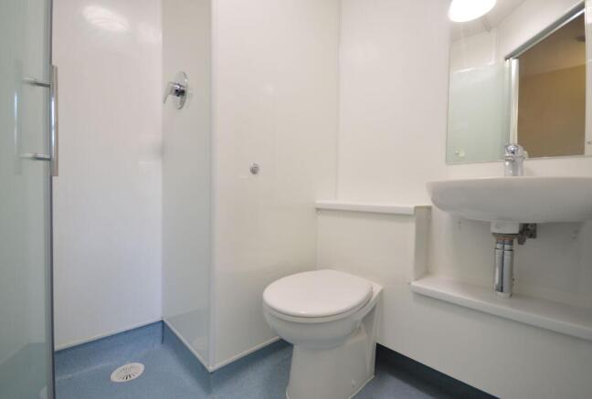 Neat modern bathroom with shower and sink...
