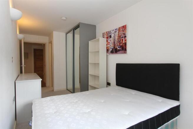 Bright modern bedroom with ample storage space...