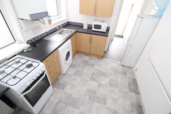 Bright kitchen with modern appliances and stora...