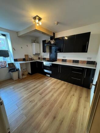 Sleek modern kitchen with ample floor space...