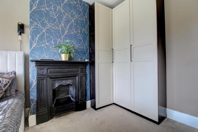 Bedroom One Fireplace & Fitted Wardrobe