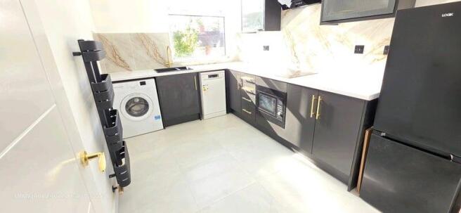 Modern kitchen with sleek dark cabinetry, ample...