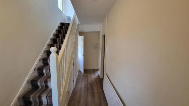 Bright, tidy entrance hallway with a carpeted s...