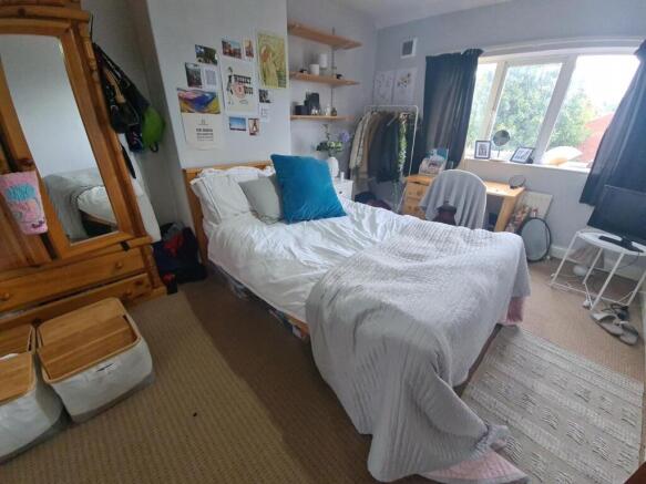 A bright and inviting master bedroom featuring ...