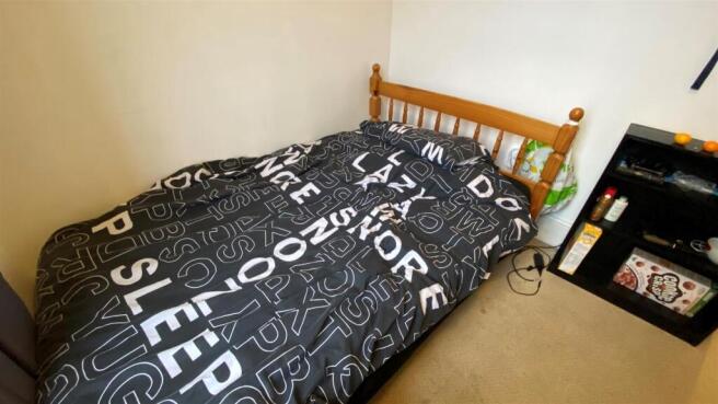 Cosy bedroom with a double bed and storage spac...