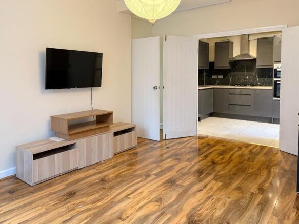Bright living area with modern wood flooring...