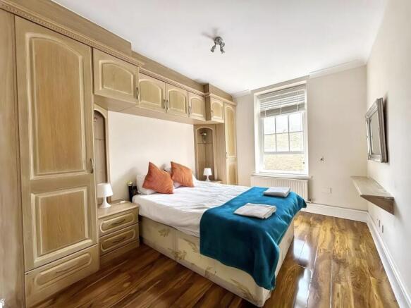 Bright bedroom with extensive built-in storage...