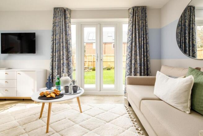 The lounge benefits from double doors leading to the garden