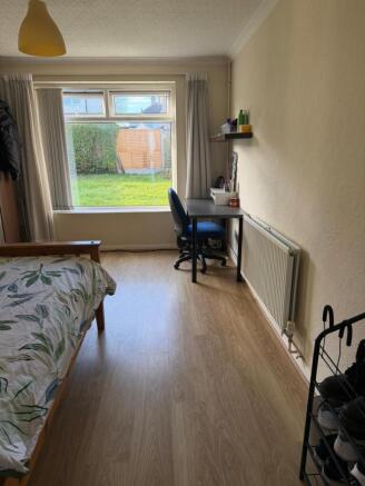 Bright, tidy bedroom with a large front window ...
