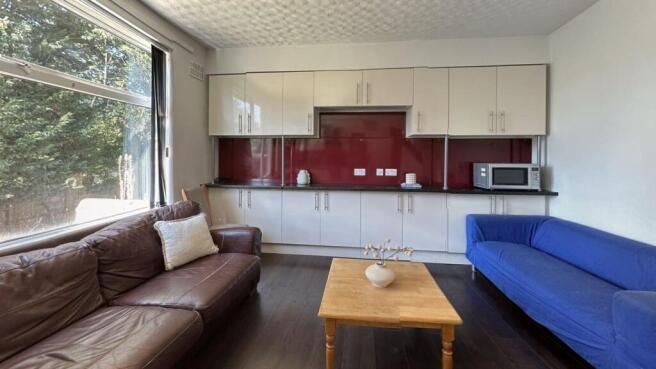 A spacious living room featuring two comfortabl...