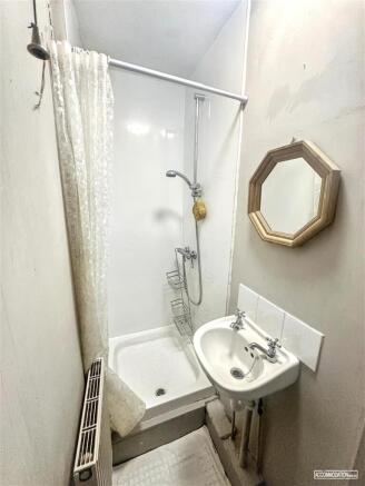 Compact bathroom with shower and sink...