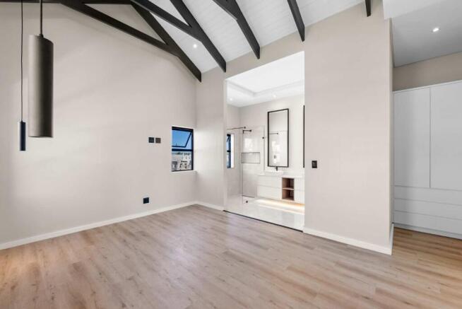 Main ensuite bedroom with built in cupboards