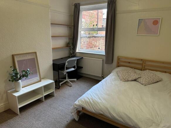 A cozy bedroom featuring a comfortable double b...